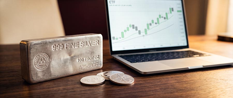 Physical silver vs silver ETFs comparison — silver bullion bars beside a brokerage screen showing SLV share price